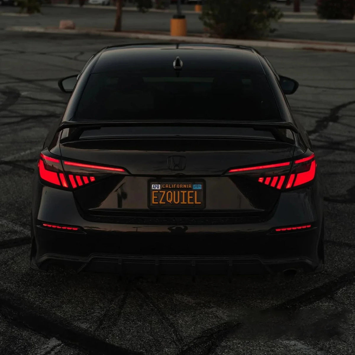 Rear view of a Honda Civic with illuminated red tail lights